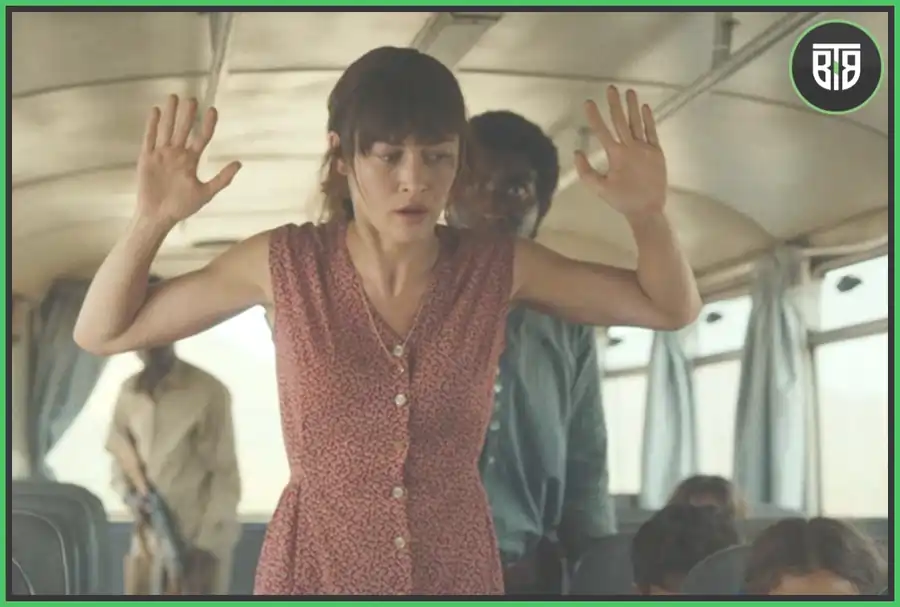 a lady's hands are raised by a terrorist in 15 minutes of War, coda apple tv 2022