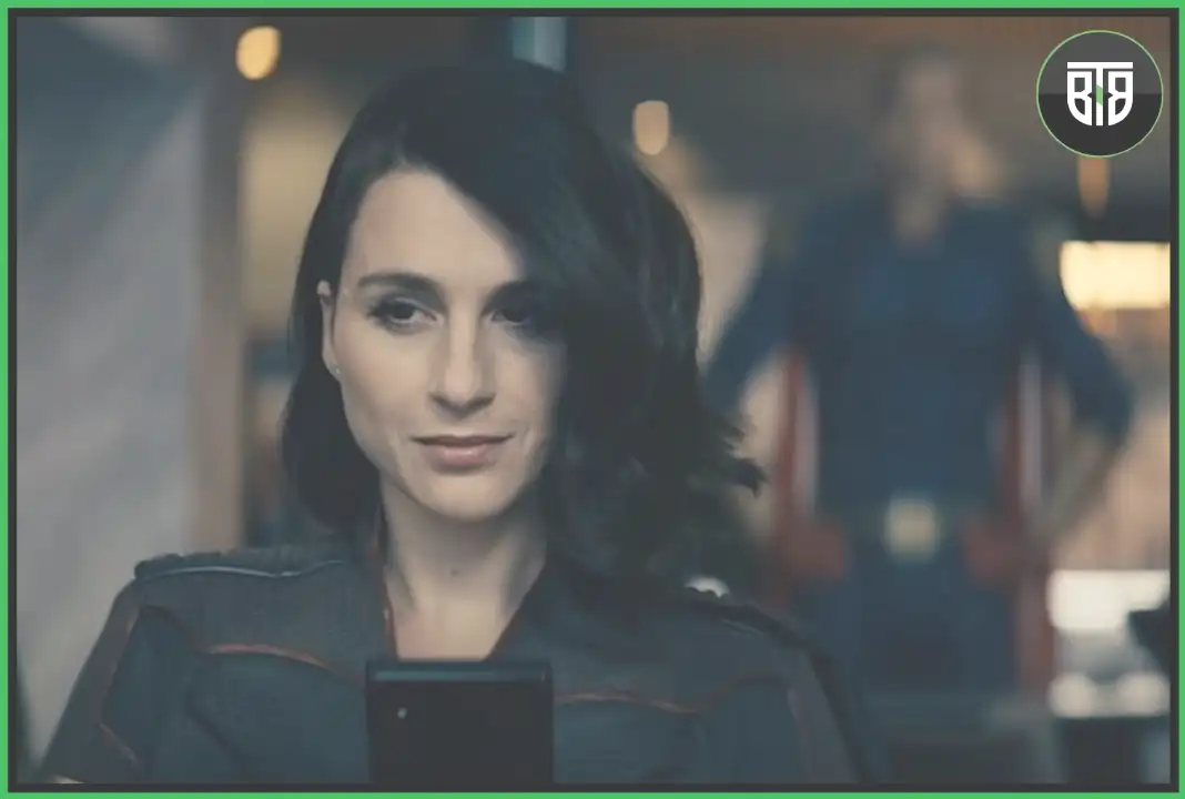 a girl is sitting on the sofa and one man in coming to her in the TV Series the Boys Season 2 Episode 3