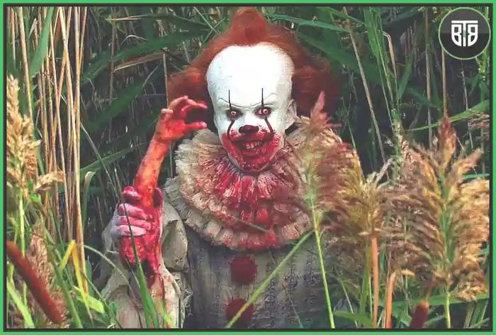  a joker is holding a cut hand piece in IT 2017, new scary movies