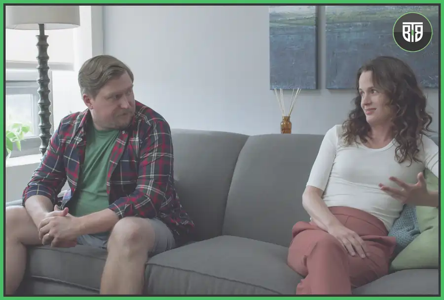 a man is watching his wife on a sofa in a romantic mood , in a movie Easygood comedy movies on netflix