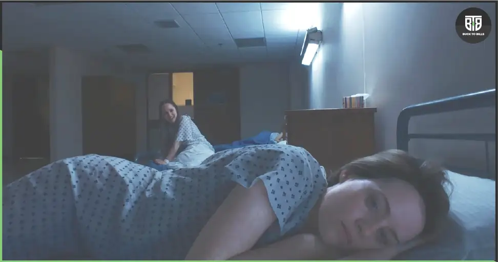 a lady is sleeping on bed and behind her a lady is staring in a Movie Unsane, horror movies on hulu