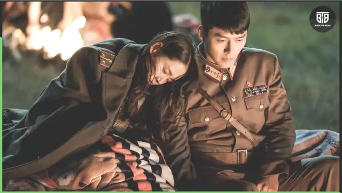 a boy and a girl are sitting near a camp fire because their plane was crashed in a Korean Drama, best korean drama on Netflix