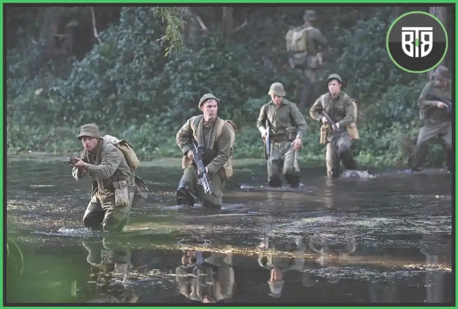 few soldiers are crossing a river in a Forest in Danger Close, top 11 movies on apple tv