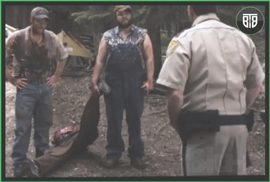 two men are holding something in front of a cop in a movie Tucker & Dale vs Evil, comedy ghost movies