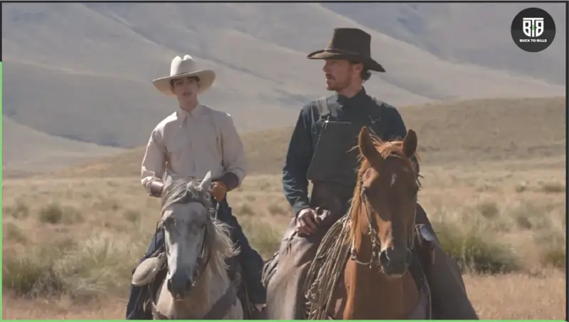 two persons are riding on horses to go somewhere in a desert, the power of the dog 