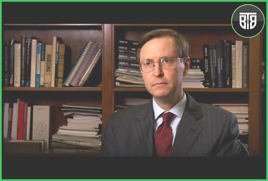 a movie scene of Inside Job 2010, where a man is sitting and behind him there is book shelf, best documentaries of all time netflix