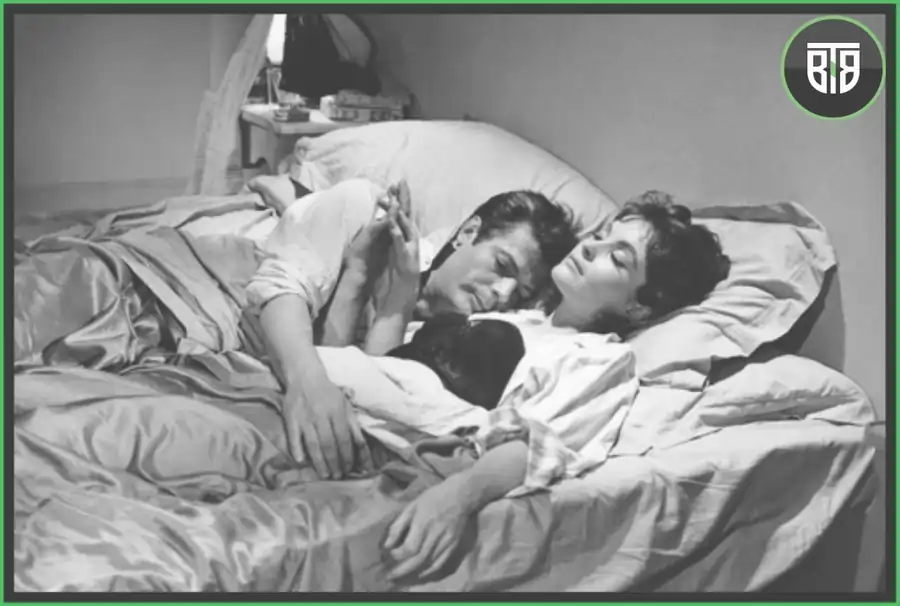 a couple is sleeping on a bed hugging each other in La Dolce Vita, criterion cinema