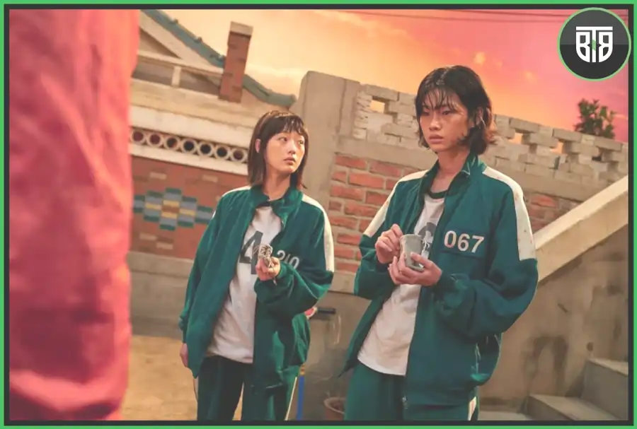 two girls who are in uniform are thinking something in Squid Game, binge tv shows