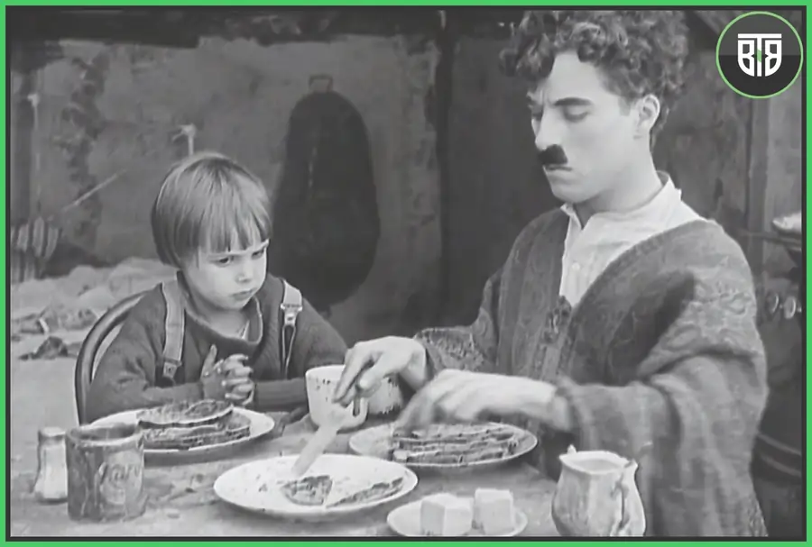 Charlie Chaplin is doing dinner with a kid in The Kid 1921 film, criterion channel app