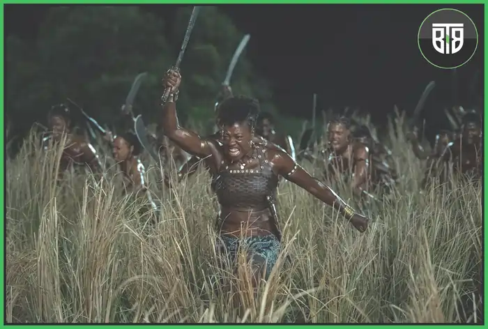 A group of women is fighting with enemies in a movie The Woman King, the king's woman