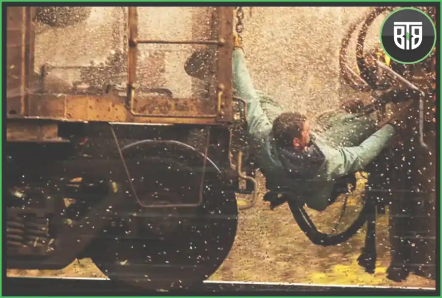 a man is hanging between two bogies of a train in Unstoppable, 2022 best shows on apple tv